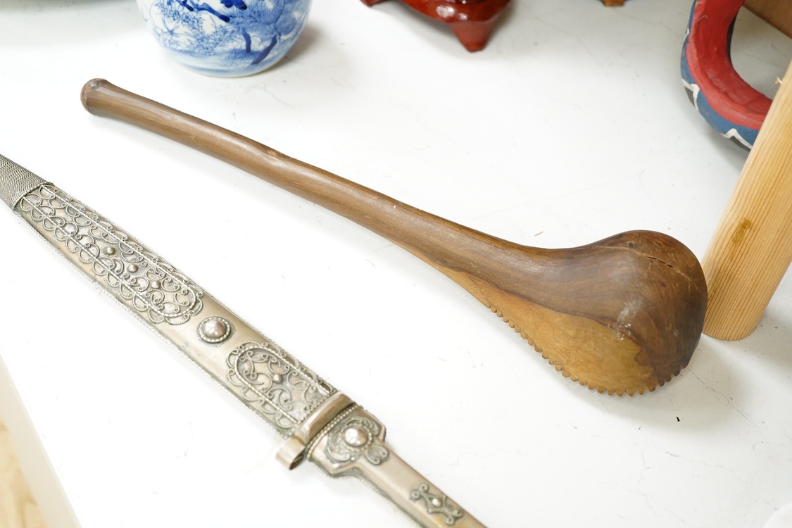An African hardwood throwing club together with a painted mask and a Caucasian style dagger kindjal, largest 34cm high